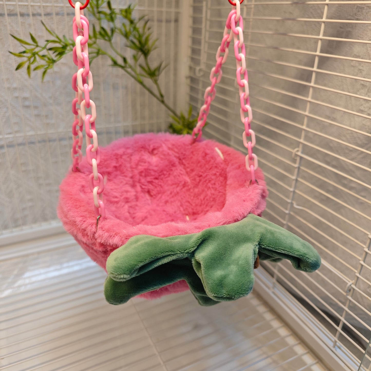 Happy Strawberry Design Parrot Bird Nest, equipped with hooks and plastic chains, suitable for cage use. The cotton-filled half-moon shape provides a comfortable sleeping spot for pet birds.