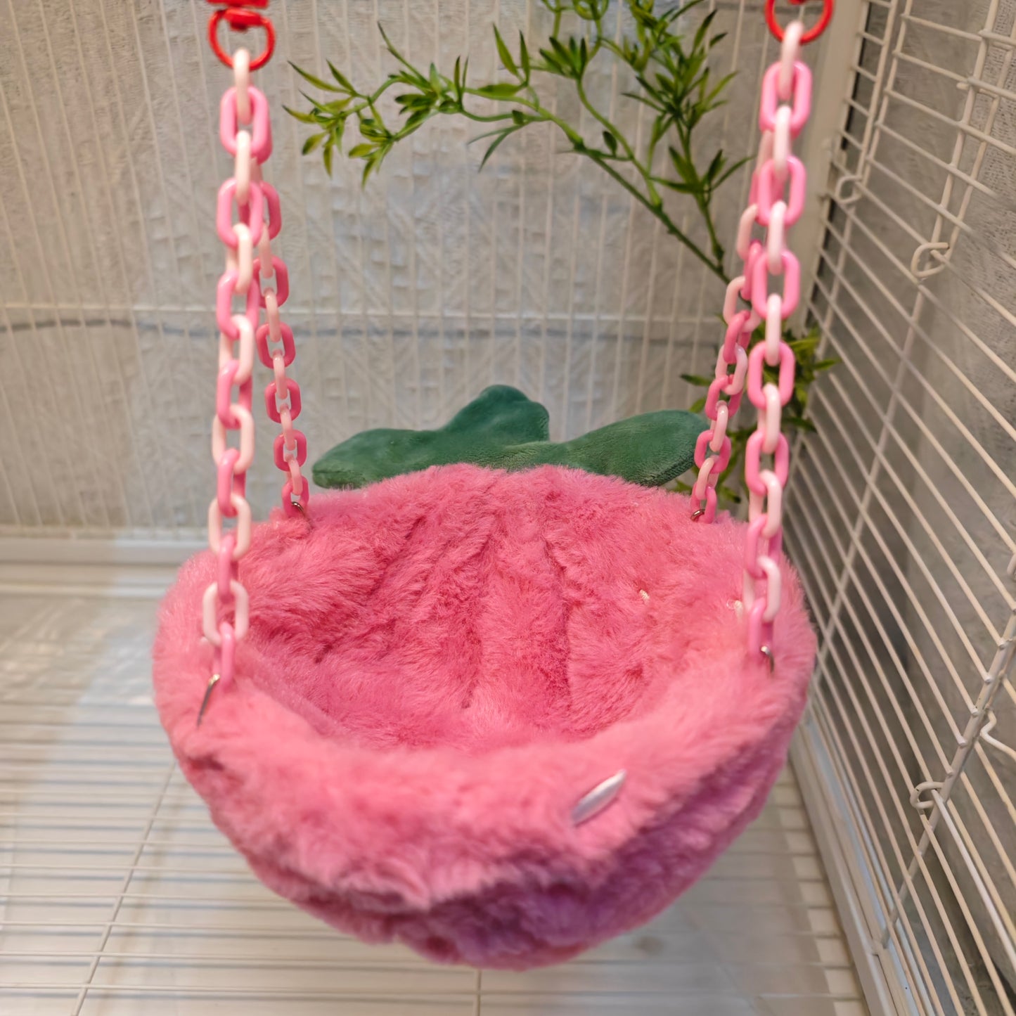 Happy Strawberry Design Parrot Bird Nest, equipped with hooks and plastic chains, suitable for cage use. The cotton-filled half-moon shape provides a comfortable sleeping spot for pet birds.